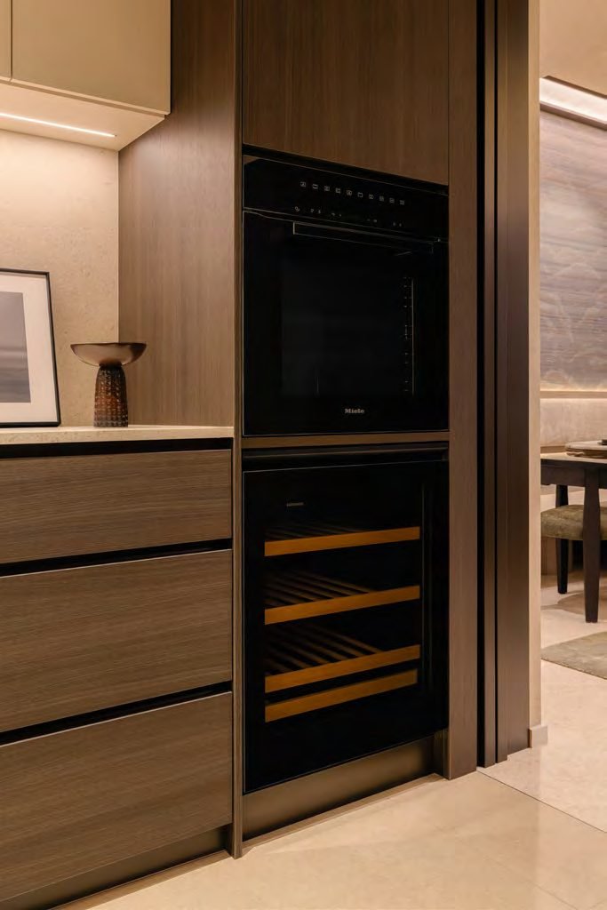 Thomson Reserve 5-bedroom suite show unit — enclosed kitchen with dark cabinetry and a window to the exterior